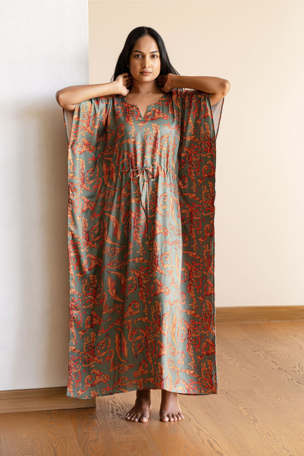The kaftan is an  ankle length long dress with flowy sleeves, made from smooth man made fibre, with a drawstring at the waist. It's free size and comfortable to lounge in.