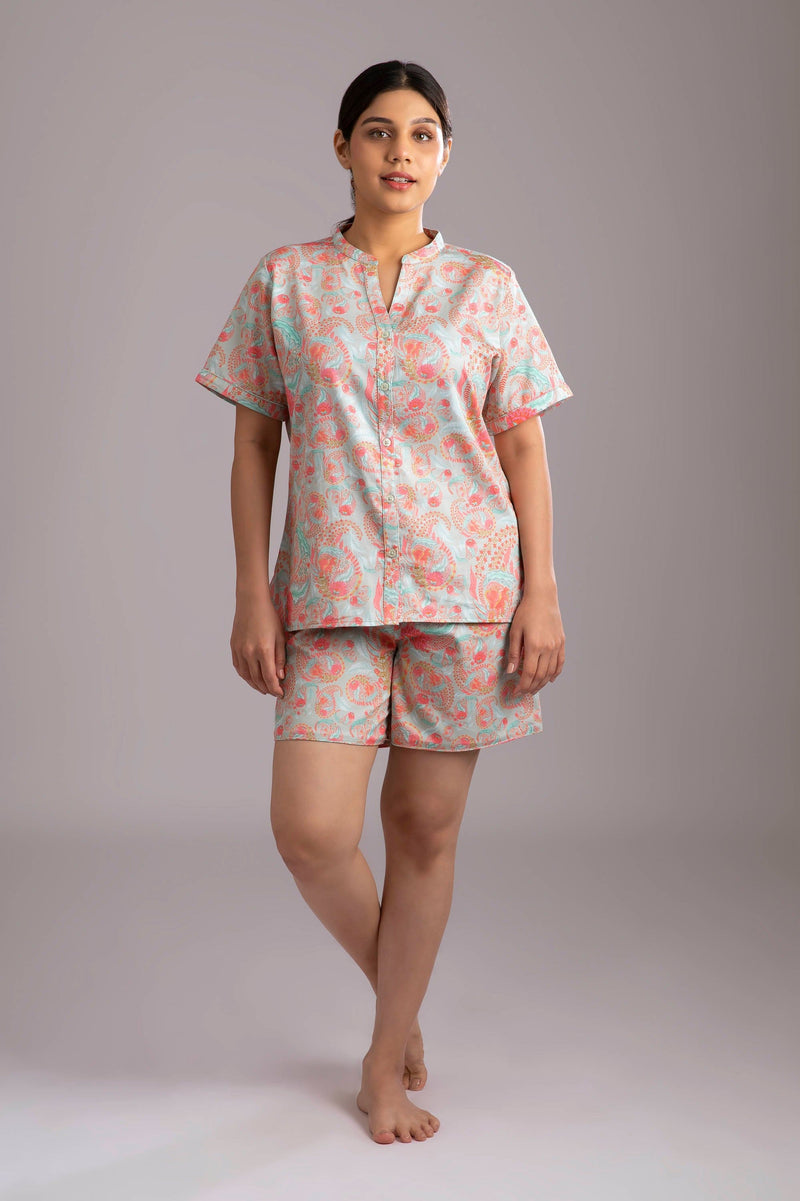 Naina-Eyes  Fabric-Cotton satin  Style-Urban  Our half sleeve night suit with a notched round neck is made from serene cotton and is coordinated with elegant shorts which have an elasticated waistband with a drawstring adding meaning to comfort and relaxation. 