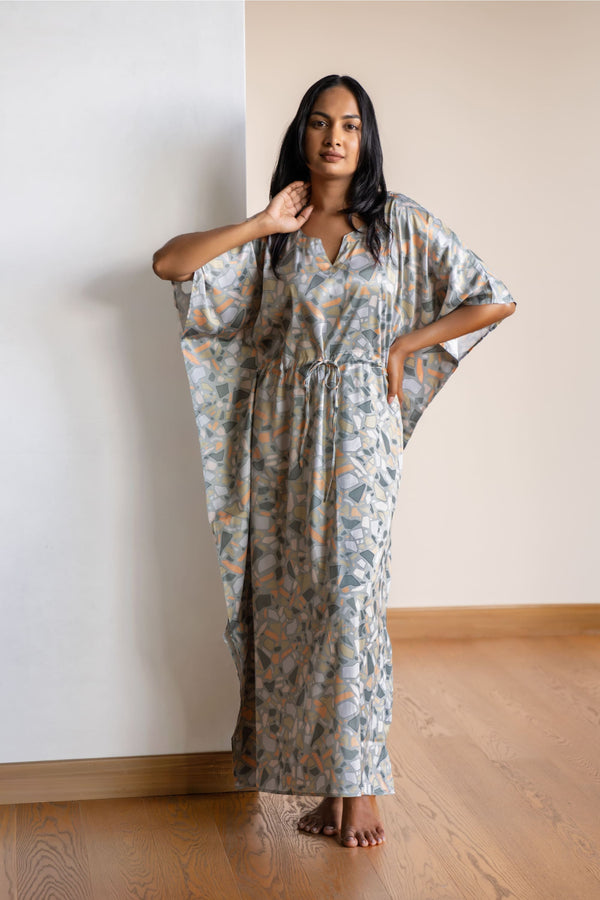 The kaftan is an  ankle length long dress with flowy sleeves, made from smooth man made fibre, with a drawstring at the waist. It's free size and comfortable to lounge in