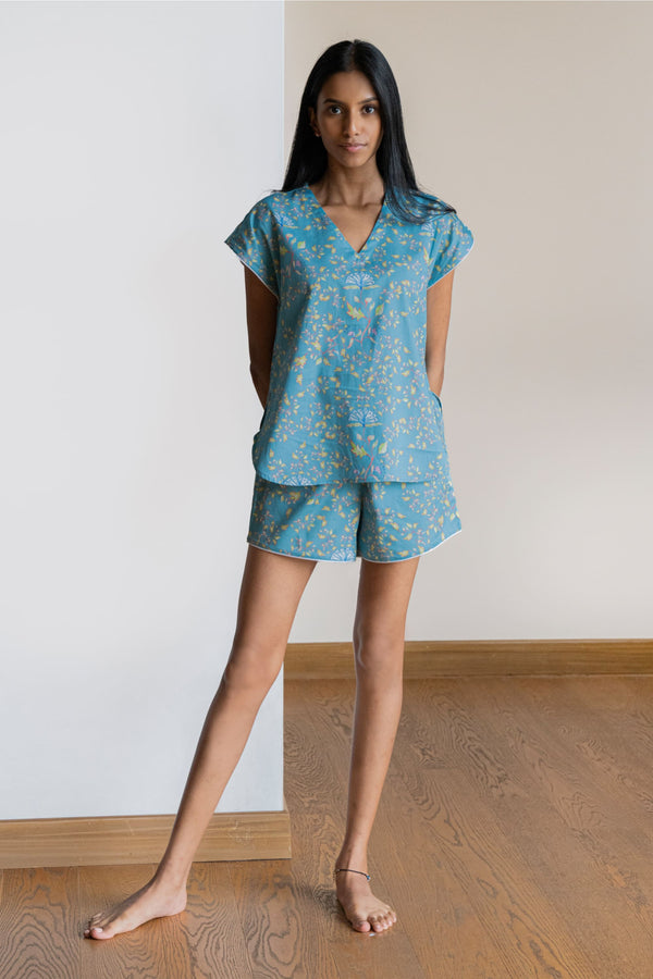 Our short  sleeved night suit set is made and trimmed from serene cotton and is perfect to lounge in. It has a relaxed silhouette top and coordinated elegant shorts  with an elasticated waistband with a drawstring adding meaning to comfort and relaxation. 