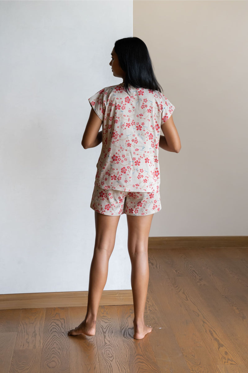Our short  sleeved night suit set is made and trimmed from serene cotton and is perfect to lounge in. It has a relaxed silhouette top and coordinated elegant shorts  with an elasticated waistband with a drawstring adding meaning to comfort and relaxation. 